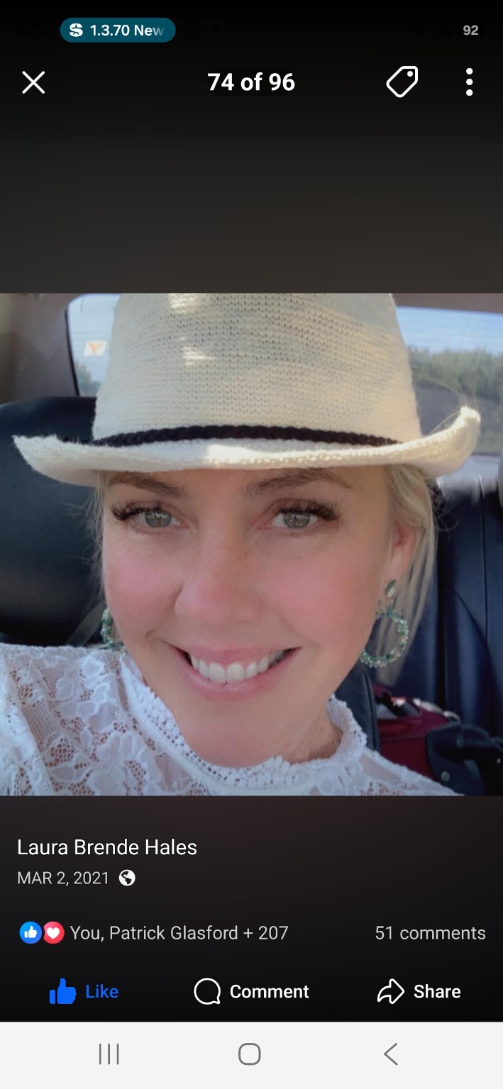 Laura Brende smiling in a white hat